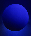 A blue ball is shown in the dark.