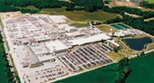 A large industrial area with many cars parked in it.