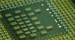 A close up of some electronic components on a green board